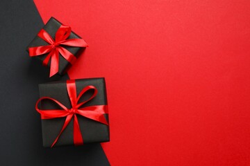 Beautiful gift boxes tied with bows on color background 