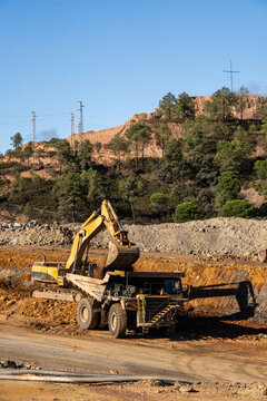 Excavator loading a truck at Rio Tinto mine in Spain