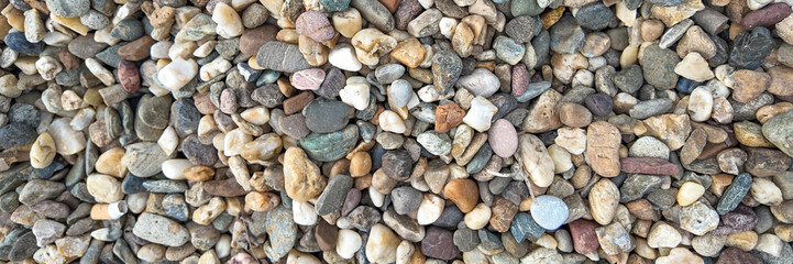 Close-up of assorted smooth pebbles, representing nature's diversity and tranquility, ideal for backgrounds or earth-related concepts