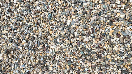 A close-up of colorful pebbles scattered on a beach, symbolizing relaxation and natural beauty, often associated with summer vacations
