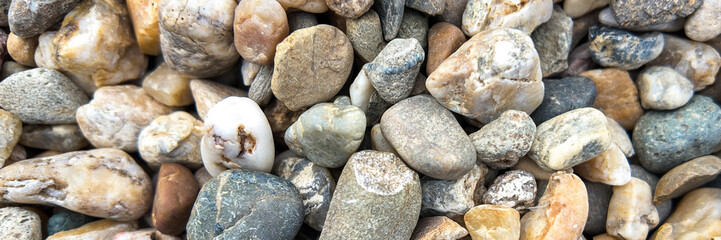 Colorful river rocks with varied textures symbolize natural beauty and tranquility, ideal for concepts of relaxation and meditation