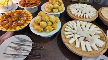 A variety of Eastern European dairy appetizers and bread are displayed on wooden boards, ideal for festive gatherings