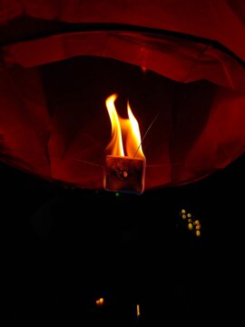 burning candle on a fireplace