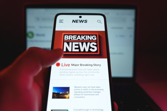 Man holding cellphone and checking latest breaking news