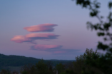 Lenticular clouds at sunset. Fascinating meteorological phenomenon in the evening sky with a particularly UFO-like appearance.