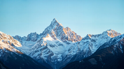 Obraz premium Majestic Snow-Covered Mountain Peaks Illuminated by Morning Sunlight with Clear Blue Sky