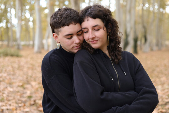 Intimate moment of LGBTQIA+ couple in an autumn setting