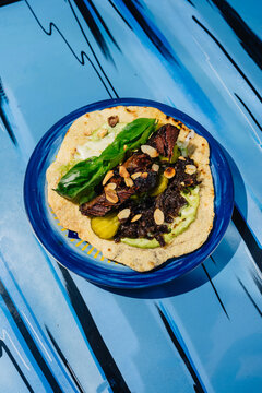 Veal cheeks tortilla served on a blue plate