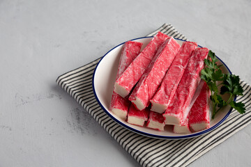 Organic Imitation Crab Meat Sticks on a Plate, side view. © Liudmyla