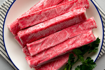 Organic Imitation Crab Meat Sticks on a Plate, top view.