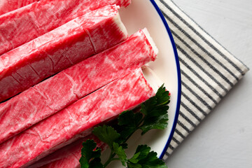 Organic Imitation Crab Meat Sticks on a Plate, top view. © Liudmyla