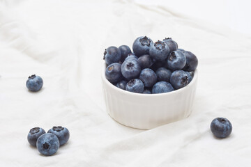 Bowl of fresh blueberries on white background. Organic farm blueberries