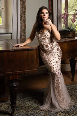 1920s woman in flapper dress standing at piano
