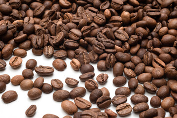 Many of roasted coffee beans on white background, closeup