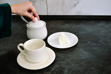 A young woman enjoys brewing coffee in her cozy kitchen early in the morning. The perfect moment to kickstart the day with a fragrant cup that energizes.