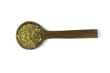 A wooden spoon of dried oregano or Origanum vulgare isolated on white background top view flat lay.