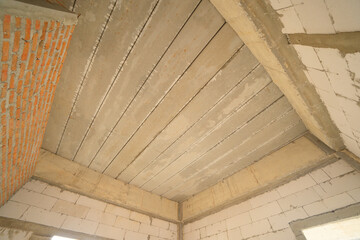 Obraz premium Under construction home or house with scaffolding on site in village. Old unfurnished rental property, living space units. lifestyle. Renovation.