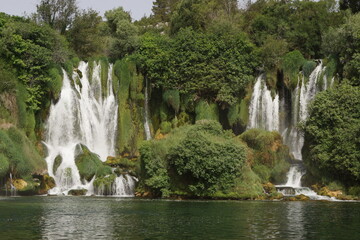 Naklejka premium The wonderful streams of the Kravica waterfall, surrounded by greenery, in Ljubuski (Bosnia and Herzegovina)