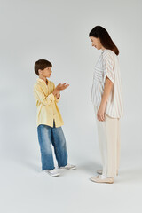 A little boy expresses joy and connection with his caring mother, highlighting their bond.