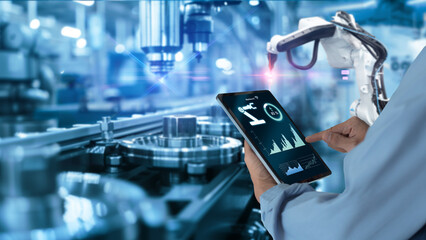Smart industry automation manufacturing control concept.Hands holding tablet on blurred automation...