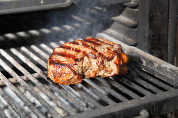 Cooking steak on the grill and coals. Roasting steak in a restaurant.
