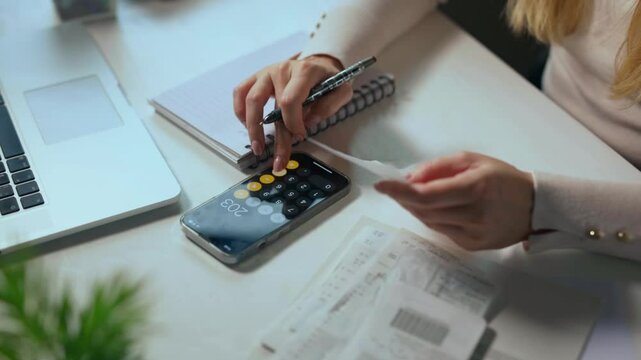 Accountant, businesswoman or banker using calculator, checking paperwork and documents while preparing financial data report in an office. Hands of a woman doing payroll or calculating annual tax - Powered by Adobe