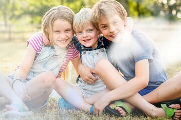 Siblings putting their arms around each other