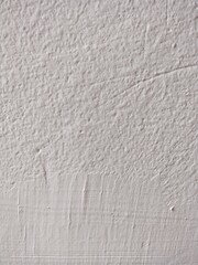 Textured white surface with scratches and marks