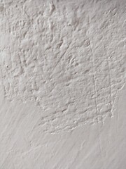 Textured white wall with scratches
