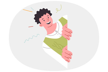 Inspired teenager looks out from behind wall, wanting to surprise friends as passed by