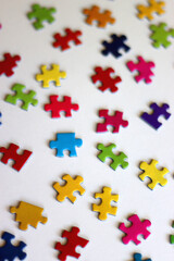Colorful jigsaw puzzle pieces on white background. Selective focus.