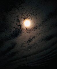 Moon shining in the clouds at night