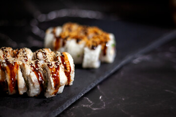 Eel sushi set. On a black background. With selective focus