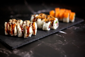 Eel sushi set. On a black background. With selective focus