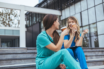 Nurses Enjoying a Coffee Break on Hospital Steps Outdoor