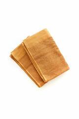 Bath towels brown color top view  isolated on white background. Pantone trend color 2025 Sudan Brown.Copy space