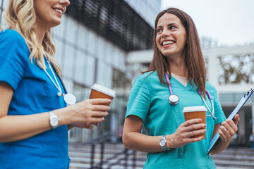 Two Nurses Enjoying a Coffee Break Outdoors Together