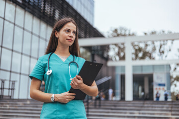 Confident Female Nurse Standing Outside Hospital Building