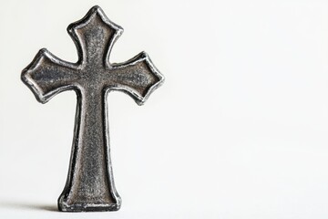 A simple metal cross on a white background, perfect for use in religious or spiritual contexts