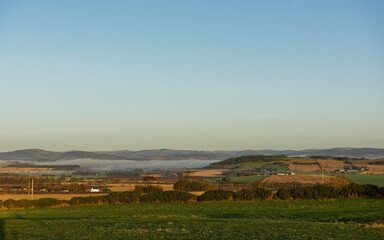 Low Cloud in parts of the Strathmore Valley under a cold clear sky with the Angus Glens in the far distance beyond the Farmland.