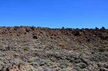 Scenic view of volcanic rock formations in desert during sunny day, Teide National Park, Tenerife