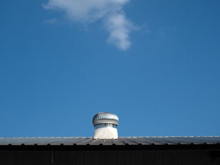 Roof ventilator on the roof with blue sky..