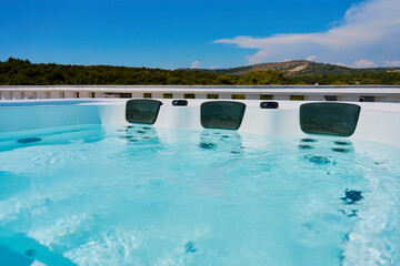 Close-up shot bubbling water in hot tub with headrests