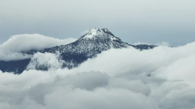 Clouds Surrounding Snowy Volcan de Colima At Nevado de Colima Volcano National Park In Mexico. static shot