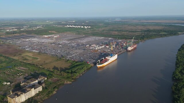 Large cargo ships importing cars in Puerto Zarate on the banks of the Paran&aacute; River. Argentina. 4k.