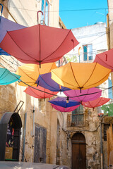Colorful Umbrellas Hanging in Narrow Alley, Sicily, Italy
