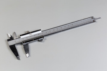 Vernier caliper with metric scales on a gray background