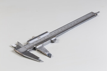 Vernier caliper with metric scales on gray background, selective focus