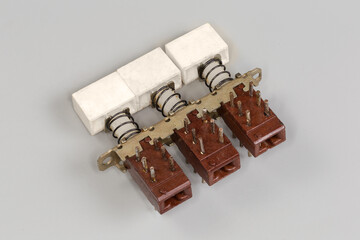 Old electrical modular push button switch on a gray background
