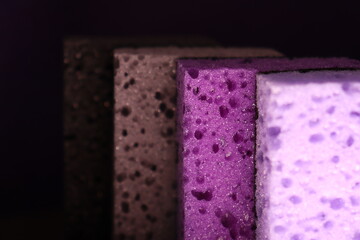 stylish dark sponges for washing dishes and cleaning on a purple background